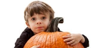 9 Tips for Surviving Thanksgiving with a Toddler Child Hugging Pumpkin